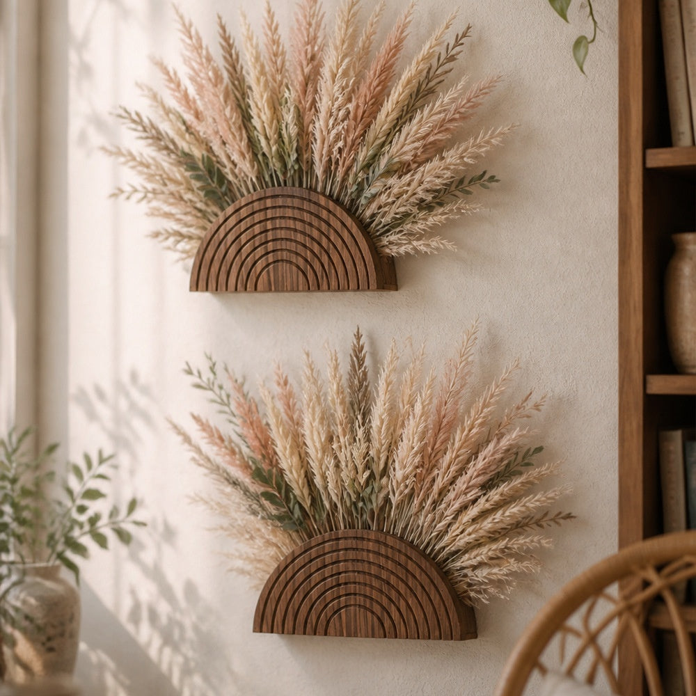 Two carved wooden arch wall pockets with dried grasses beside a bookshelf